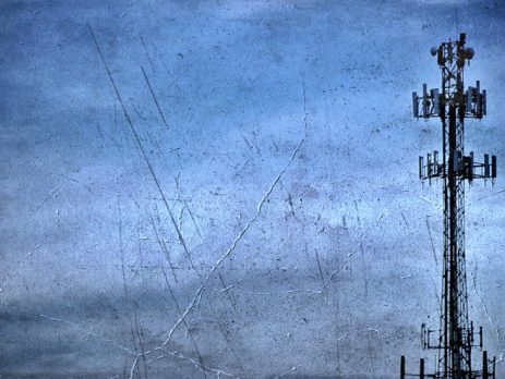 Tall telecommunication tower against a cloudy sky representing AIS 4G network failure and obsolescence in Thailand