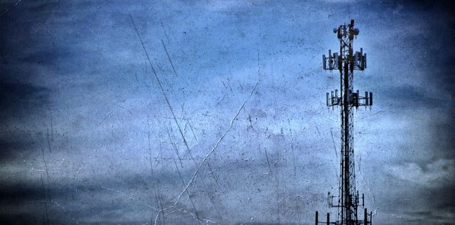 Tall telecommunication tower against a cloudy sky representing AIS 4G network failure and obsolescence in Thailand